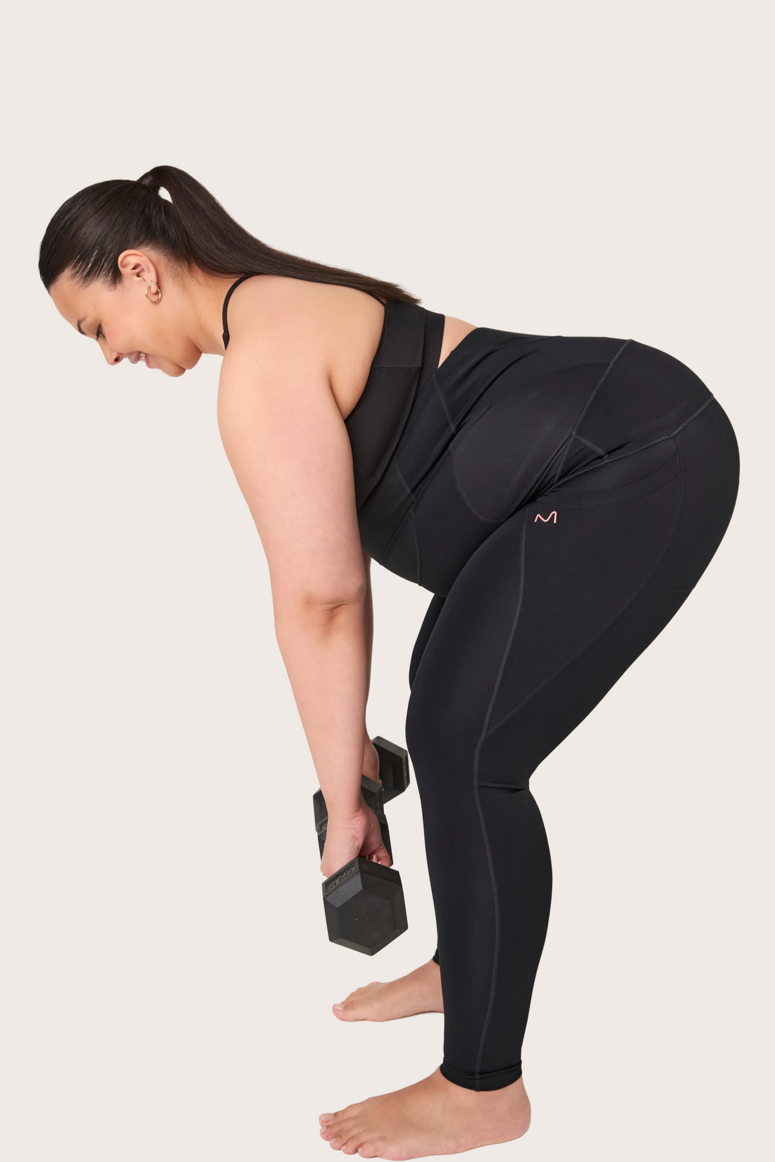 Pregnant woman wearing Everform maternity support leggings with pockets